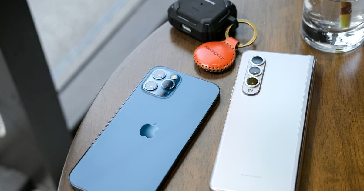 Deux smartphones posés côte à côte sur une table en bois